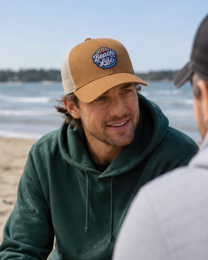 The snapback in caramel with the signature patch, worn on Wasaga Beach